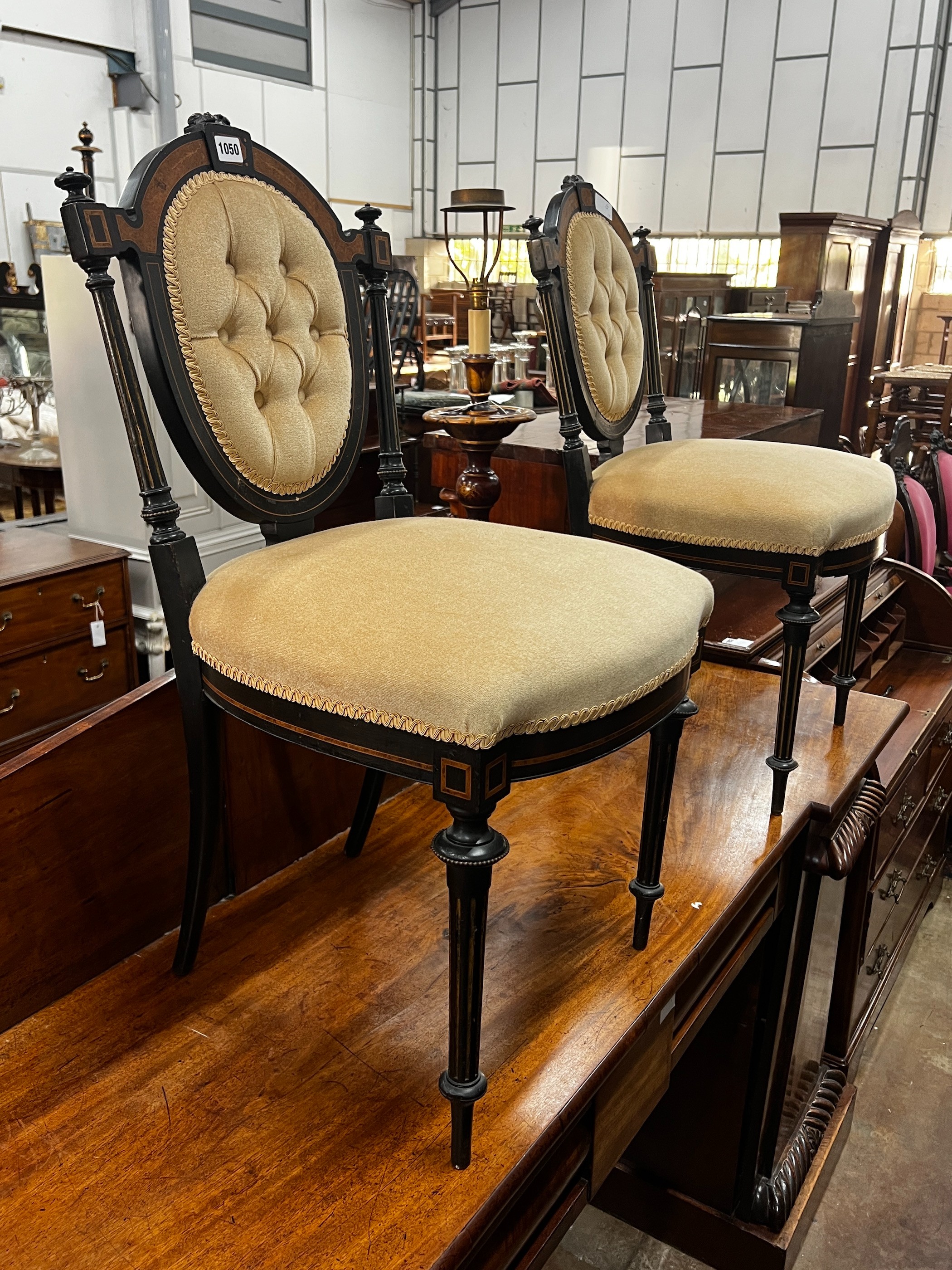 A pair of late Victorian ebonised side chairs